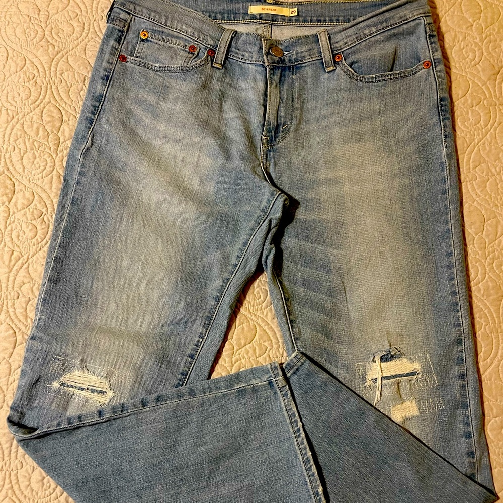 Levi Women Boyfriend Jeans light wash ripped with patches.